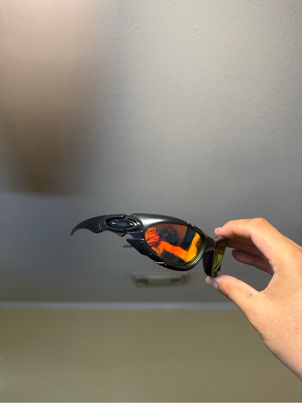 Oakley Black Frame Sunglasses with Orange-Red Mirrored Lenses